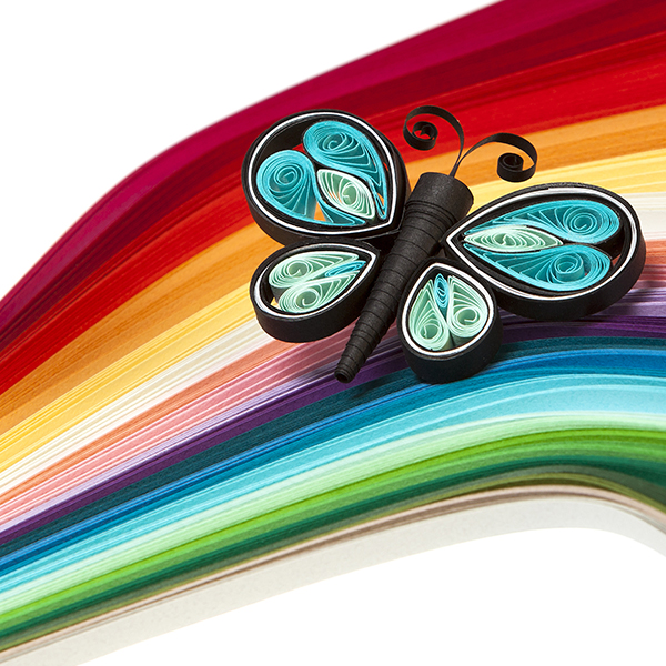 Rainbow of paper quilling strips and a paper-quilled butterfly